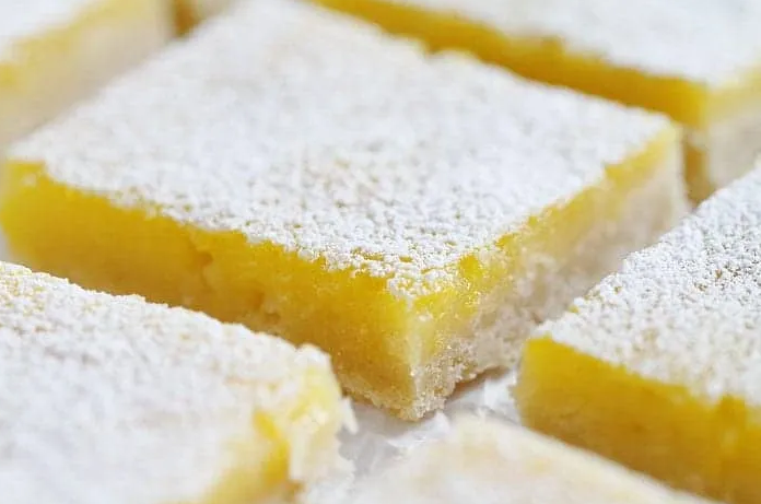 Rich, lemony bars with powdered sugar topping